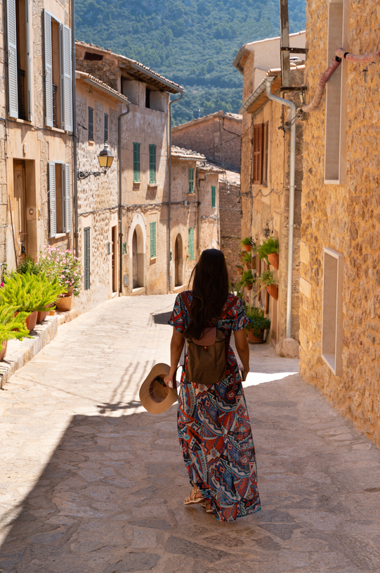 A woman walking through the streets of Valldemossa