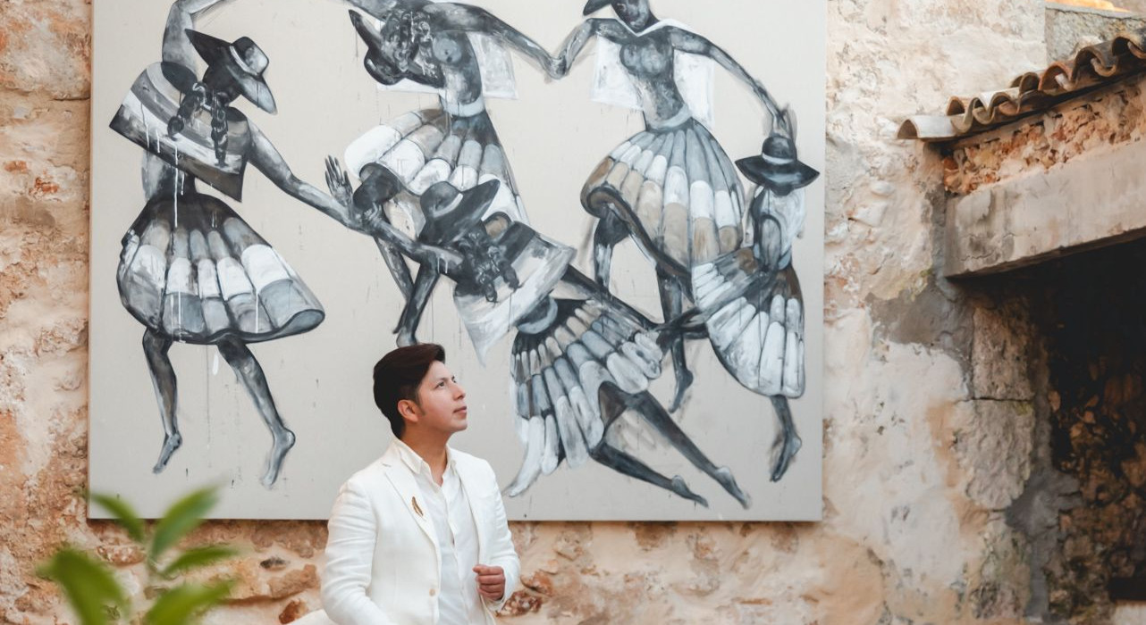 Artist Lucio Sanz standing beside his artwork at his home / gallery in Muro, Mallorca.