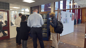 Four people looking at an exhibition