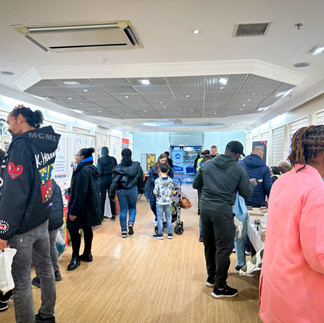 Busy shop with multiple customers visiting stall and activities in the pop-up market