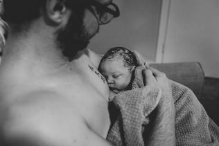 new dad snuggling baby after Arizona home birth Photography