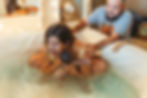 mother lifting baby into arms from birth pool after midwife-supported home birth in Phoenix, Arizona