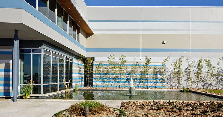 Eye-level view of a modern industrial building with large windows