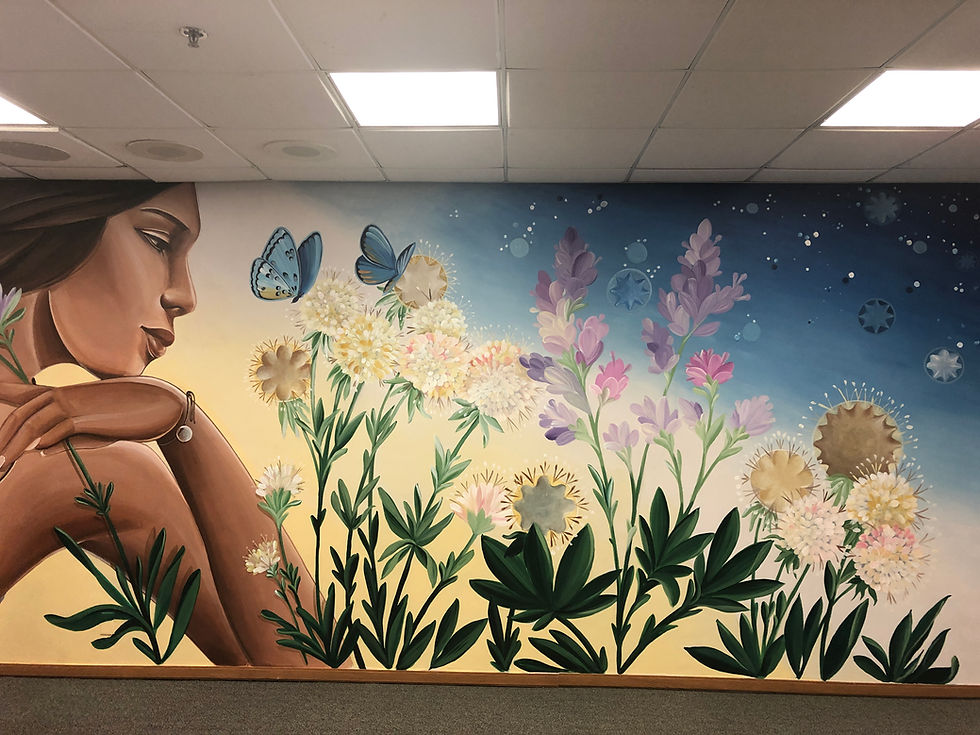 A mural by Nanibah Chacon featuring an indigenous woman looking at native flora and cog stones