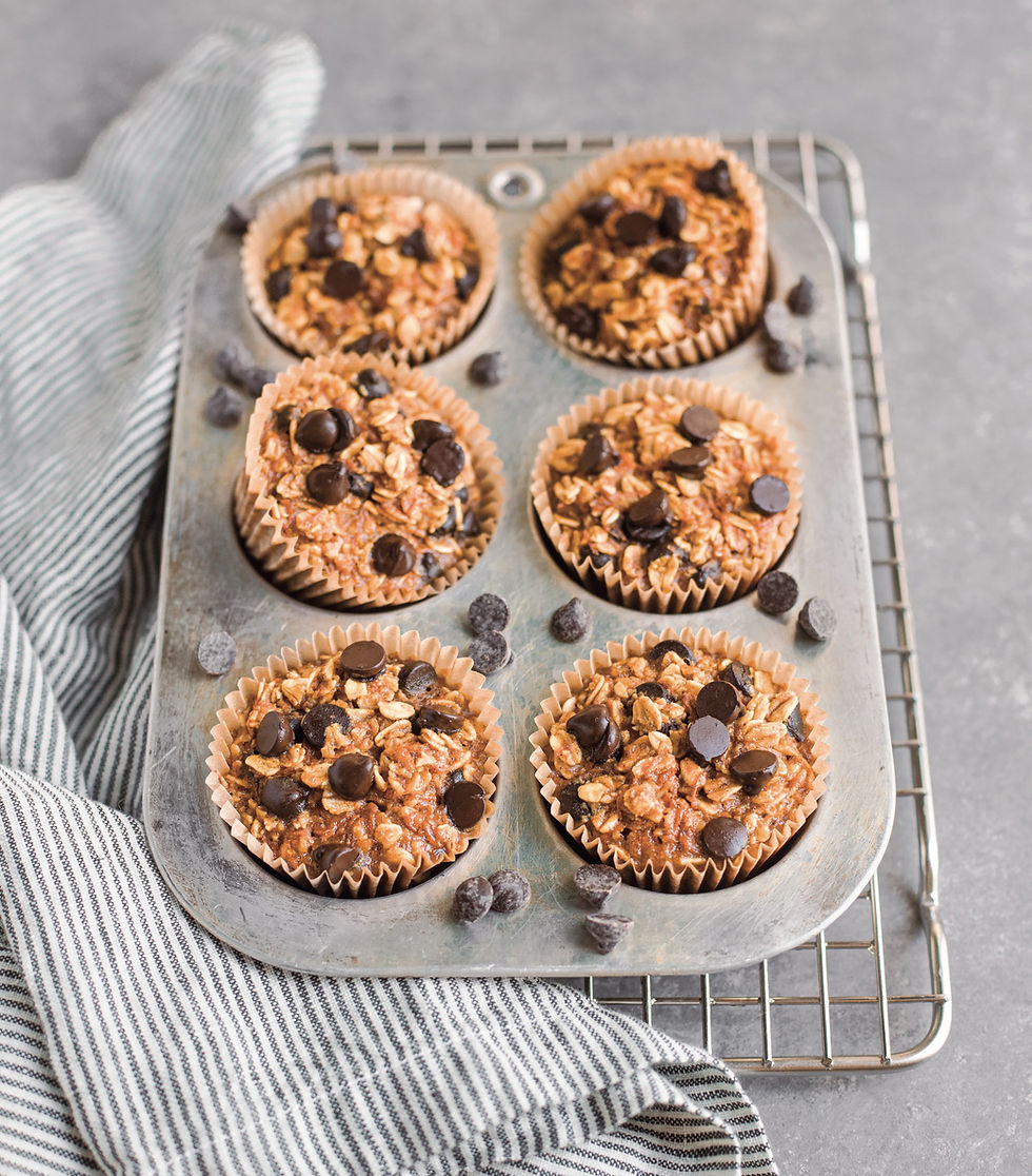 Pumpkin chocolate-chip muffins in tin with linen towel and cooling rack