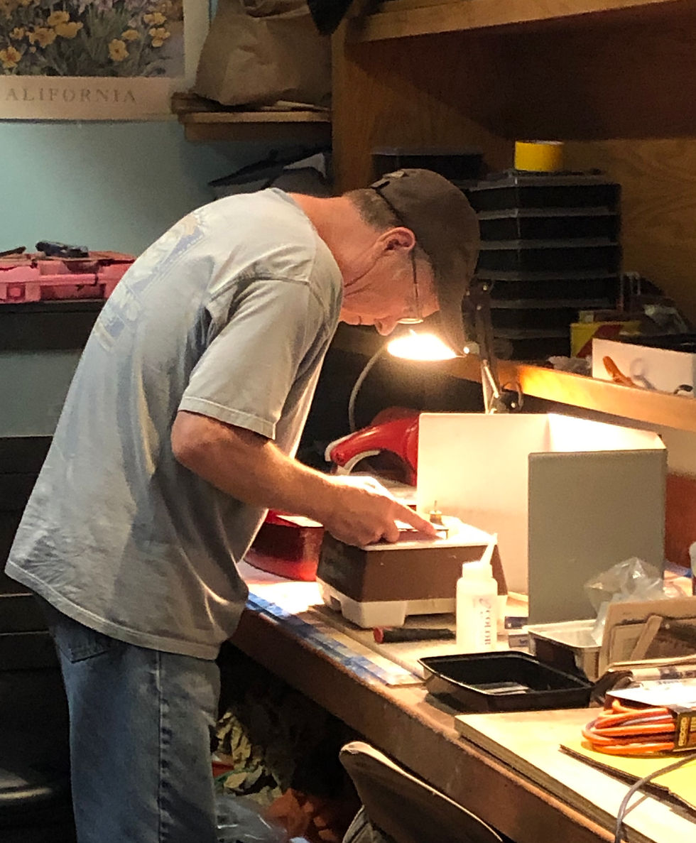 The artist Webb Holcomb working on a glass artwork in his home studio.