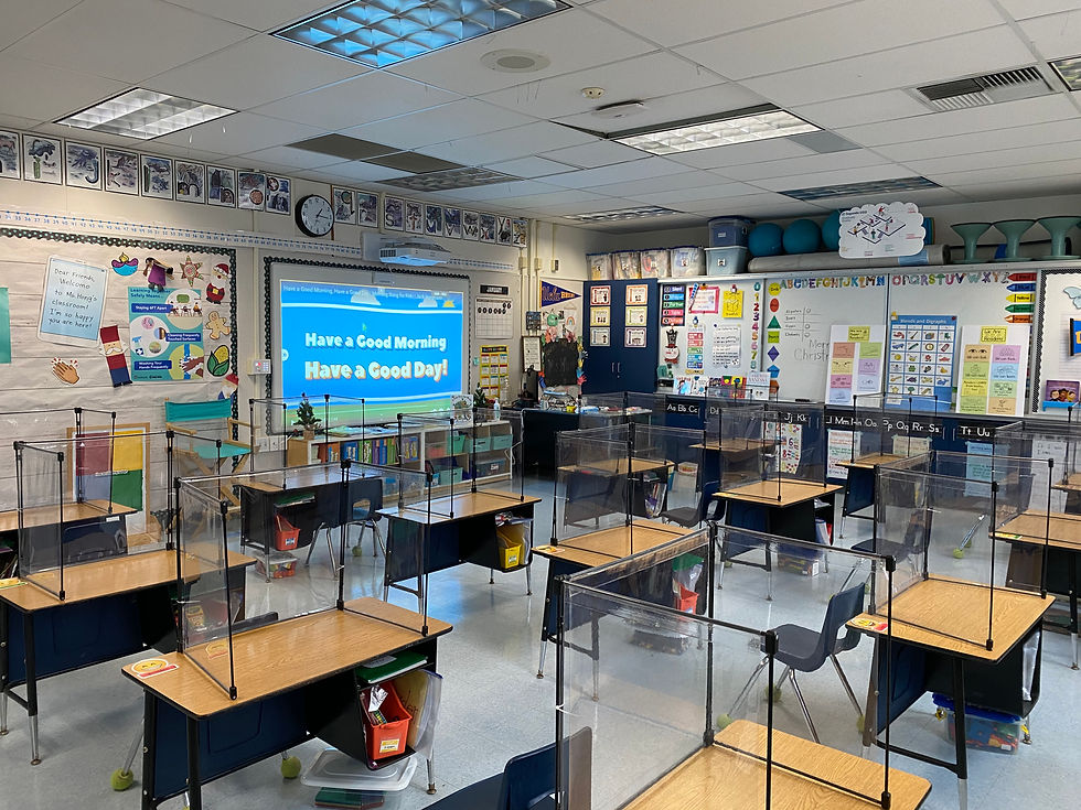 A primary classroom is cleaned, socially-distanced, and set up with Plexglas dividers during the covid-19 pandemic.
