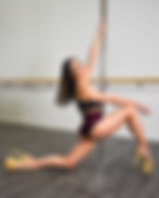 A woman wearing heels, lunging next to the pole. Pole Dance, Pole Studio, Fitness Classes, Pole Dance Class, Pole Dancing Lower Hutt, Pole Fitness, Pole Fitness Classes.