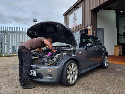 A technician inspects a Mini Cooper outside Torque Monkey garage in Chelmsford, Essex as part of the vehicle service