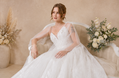a fairy tale wedding dress with tulle wings, a beautiful beaded bodice with glitter detail and an aline skirt with lots of detail and lace, thin beaded straps with a small plunge in the neckline. What a Fairy tale Wedding Dress