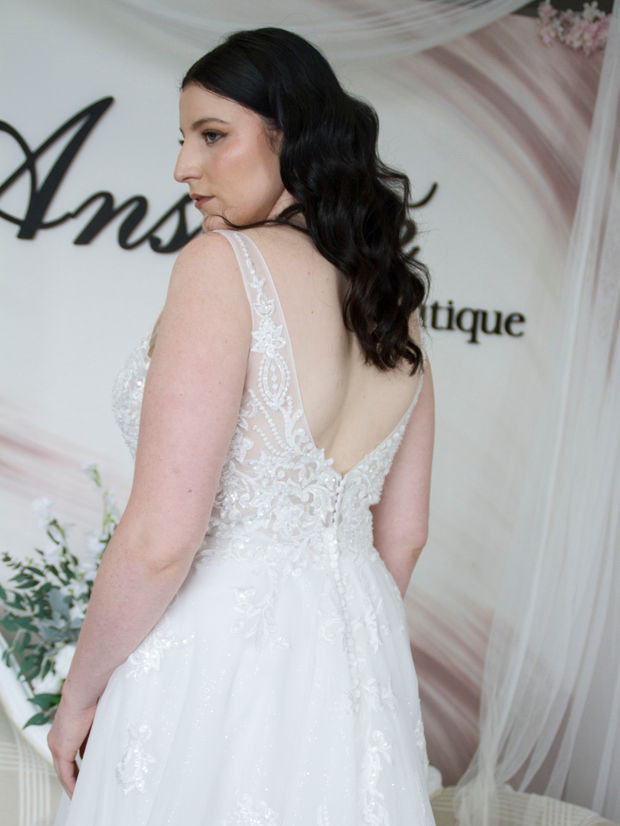 Sparkling plus-size wedding gown with a V-neckline, plunging beaded bodice, soft tulle skirt, and long train – Odette, a fairytale bridal dress.