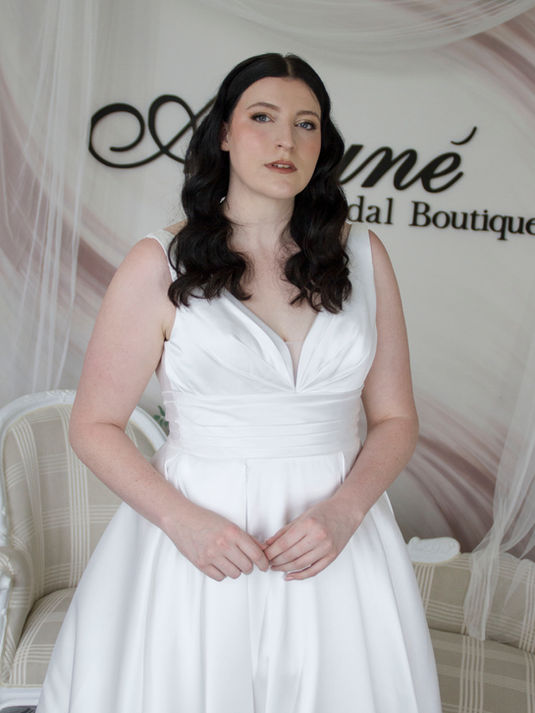 A-line Mikado wedding gown with bold folded waistline, V-neckline, and ruching on the bodice for a classic bridal look.