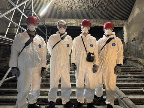 With protective suits and face masks
