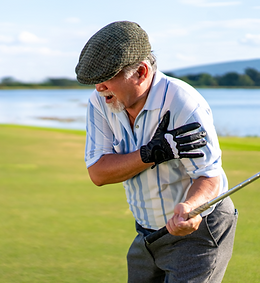 Golfer holding shoulder in pain