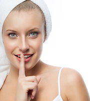 Day Spa woman holding finger to mouth with secret