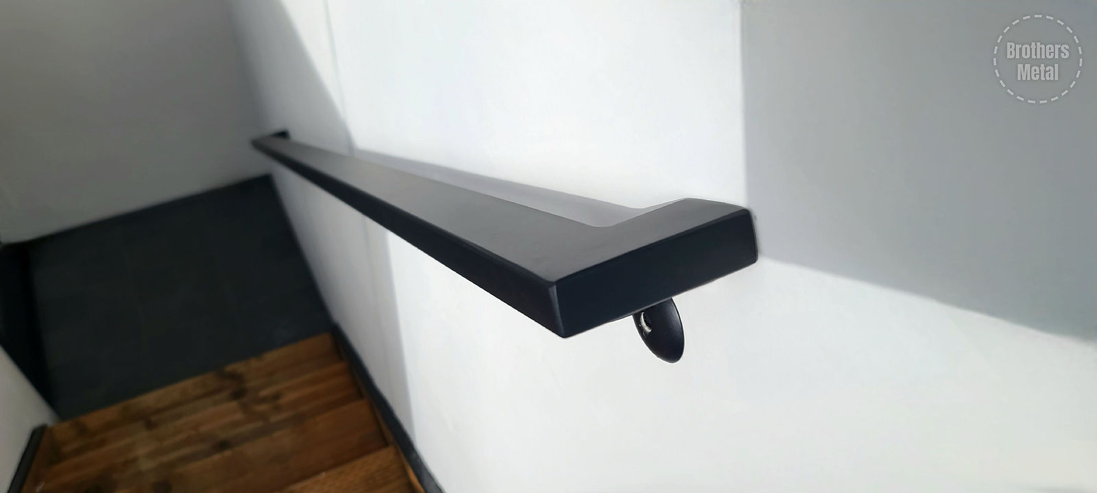 Wall-mounted steel grabrail at a side entry in Seattle, WA — view 2