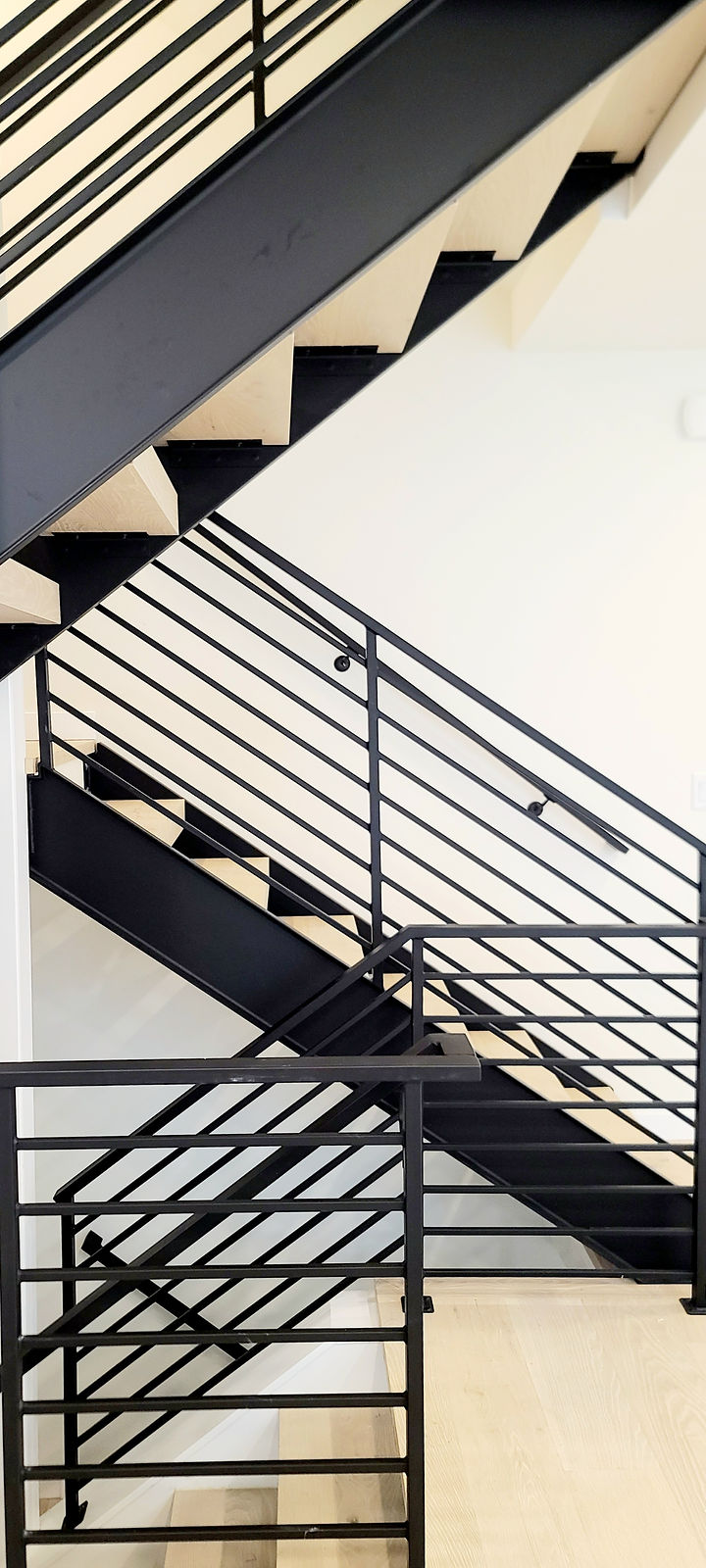 Interior steel guard rails with horizontal bar infill and matching wall-mounted handrail. — view 7
