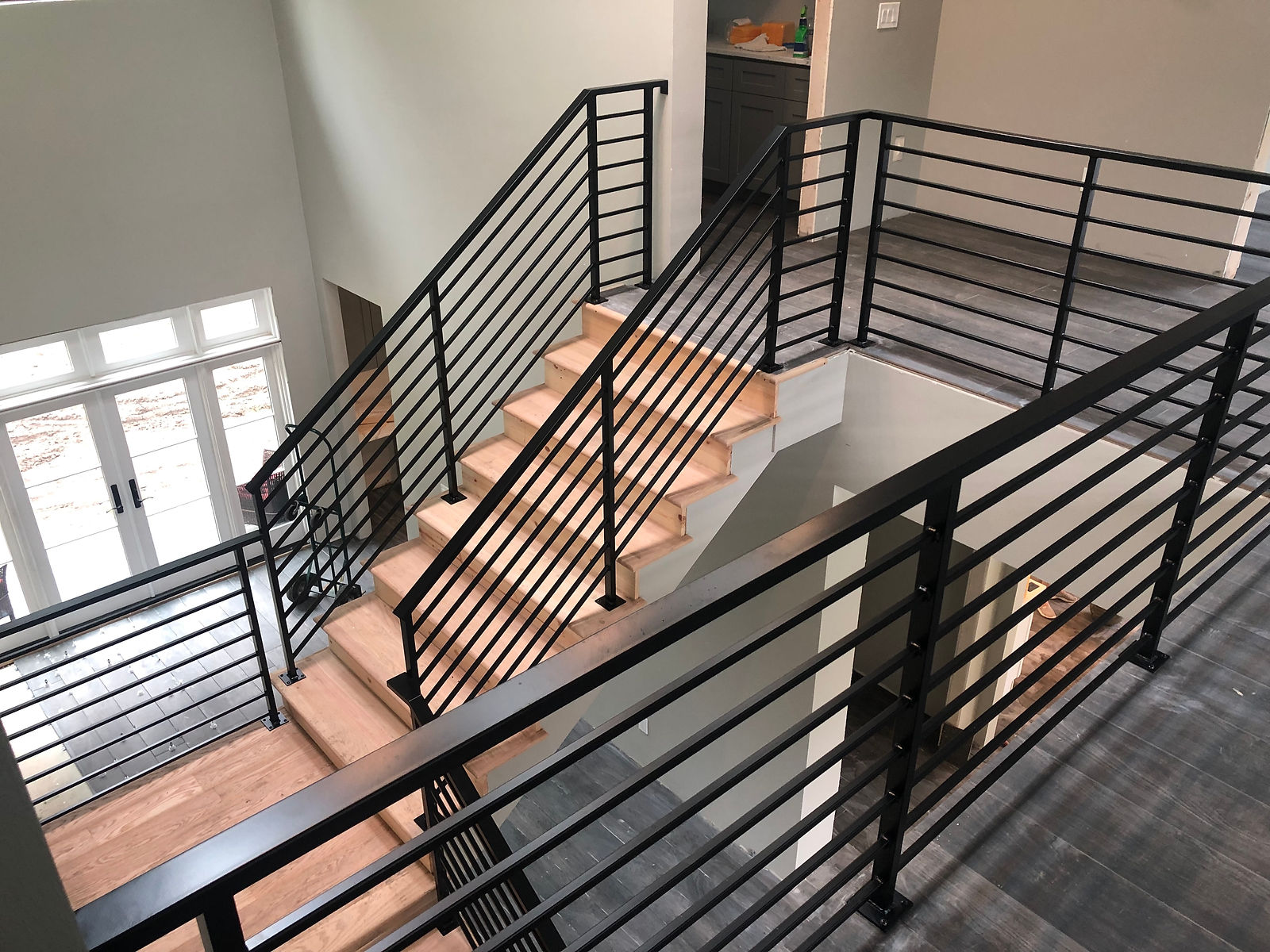 Interior steel guard rails with horizontal bar infill wrapping a landing. — view 6