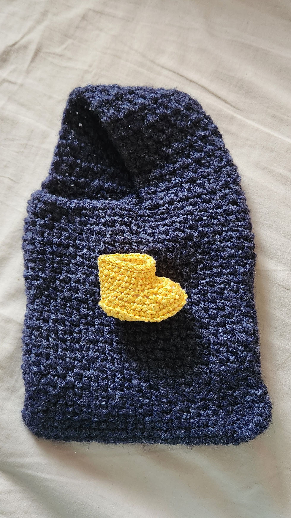 A navy deep blue single handle bag, minimalist design, with Amigurumi Yellow Rain Boot