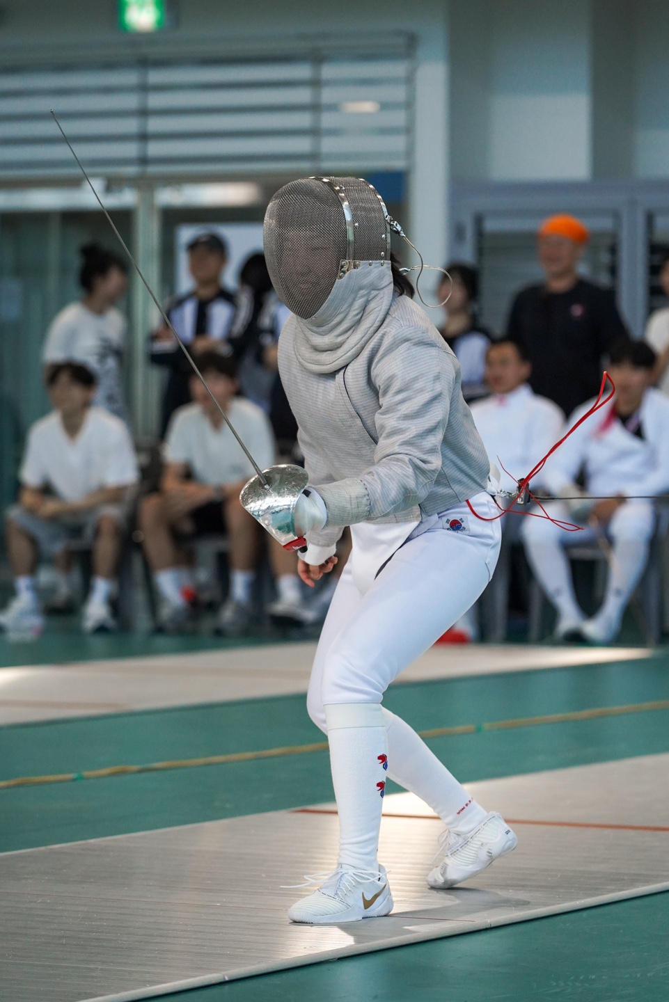 Dohui Kim competing in sabre fencing