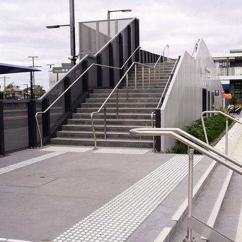 DDA compliant stainless steel ramp and stair handrails designed and installed for high-traffic public infrastructure at South Geelong Train Station.