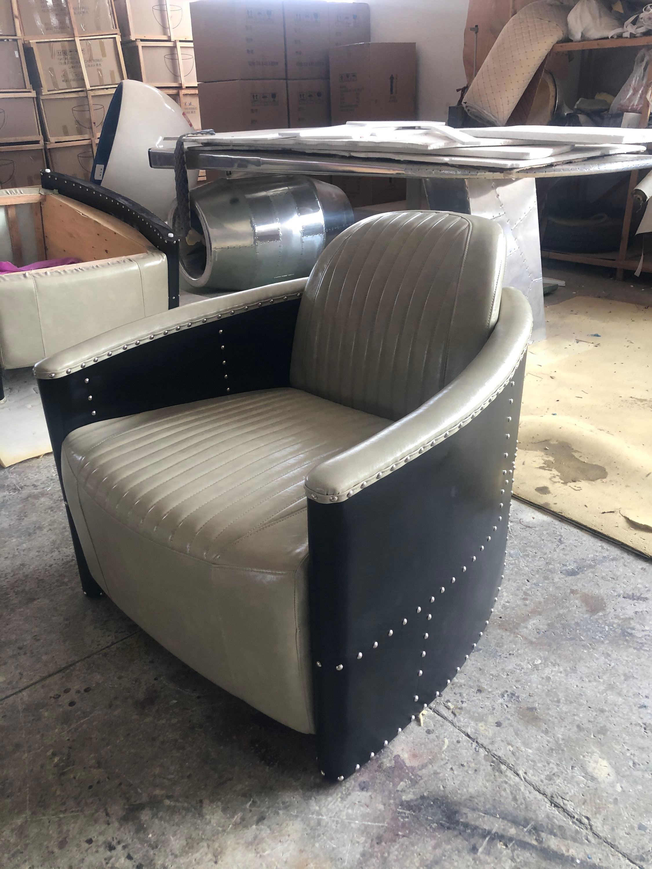 Beige Leather Accent Chair with Channel Tufting and Black Riveted Sides