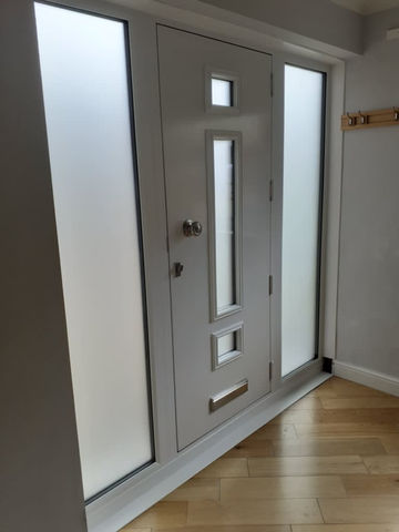 White front door with frosted glass panels