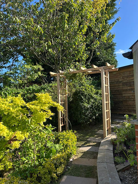 A lush garden with new wooden joinery