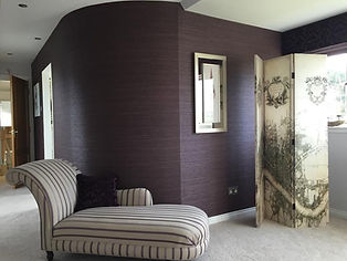 Purple wallpaper with striped seat in front