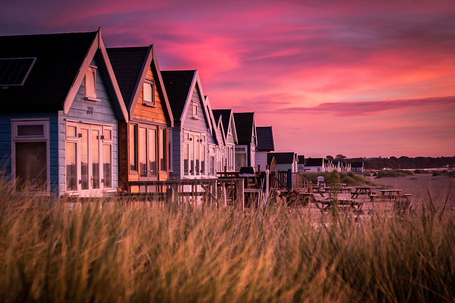 Beach huts against pink sunset