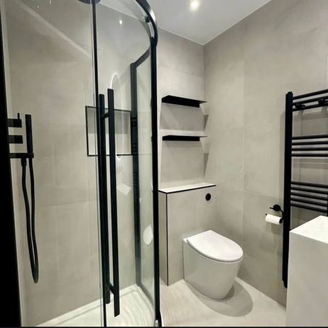 White and black bathroom with black radiator