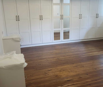 Dark wood flooring in bedroom space