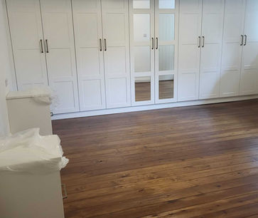 Dark wood flooring in bedroom space