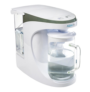 AquaTru countertop water filter with clear glass carafe filled with purified water