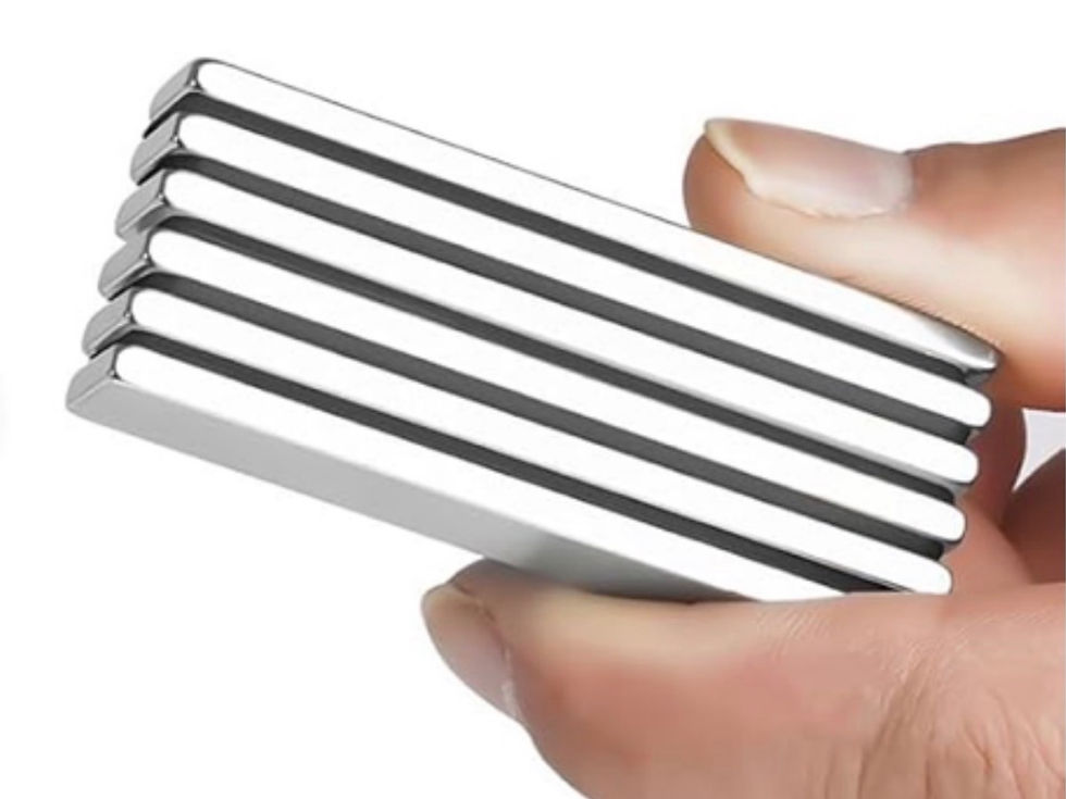 Hand holding a stack of shiny silver rectangular bar magnets against a white background.