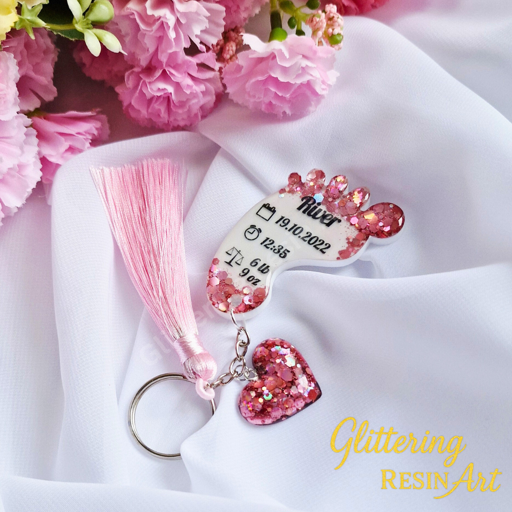 Custom baby foot resin keychain with personalized birth details including name, date, weight, and time.