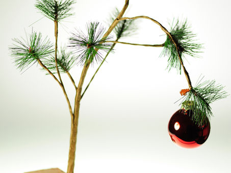 small tree with heavy christmas ball