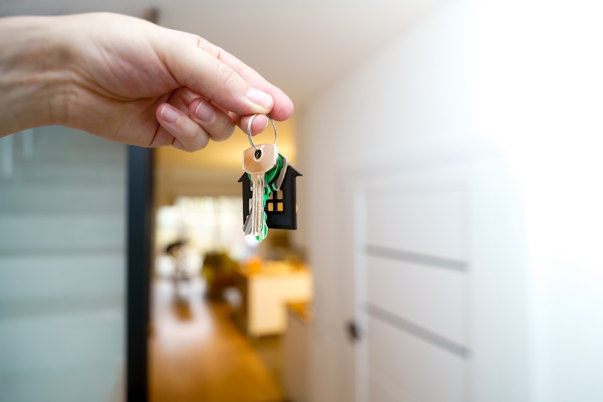 Hand holding house keys representing a 2-1 mortgage rate buydown for Lakewood, CO home buyers
