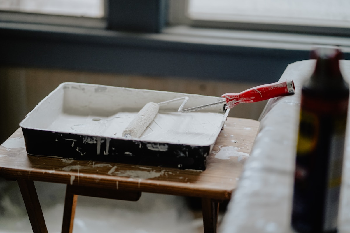 Paint roller and supplies used for pre-listing repairs before selling a home in Lakewood, CO