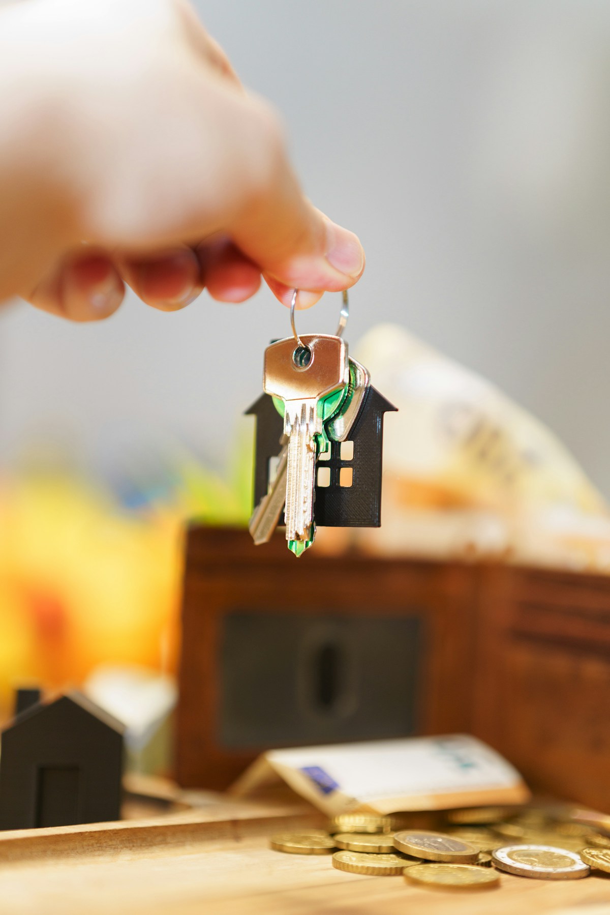 House keys and cash representing down payment assistance programs for Lakewood, CO buyers