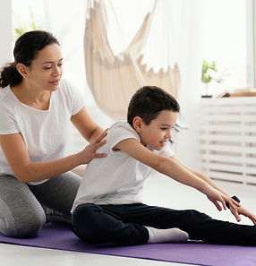 full-shot-woman-boy-yoga-mat.jpg