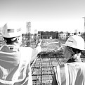 man in white hard hat standing on brown