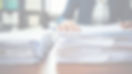 person working with a stack of papers in an office setting