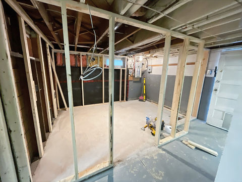 Other angle of the concrete floor leveling and framing of the basement bathroom. 