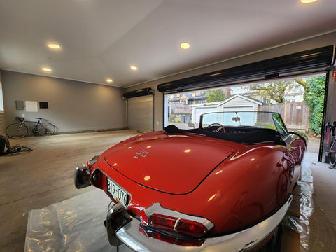 Other angle of garage build interior with concrete and pot lighting 