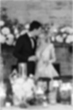 The Bluffs at Conner Prairie wedding photo of bride and groom kissing at Reception surrounded by flowers and candles