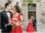 Bride in a red lehenga and groom in a black tuxedo in the garden of the Indianapolis public library