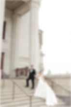 Photo of bride and groom on the steps of the Palladium Center for the performing arts center in Carmel Indiana