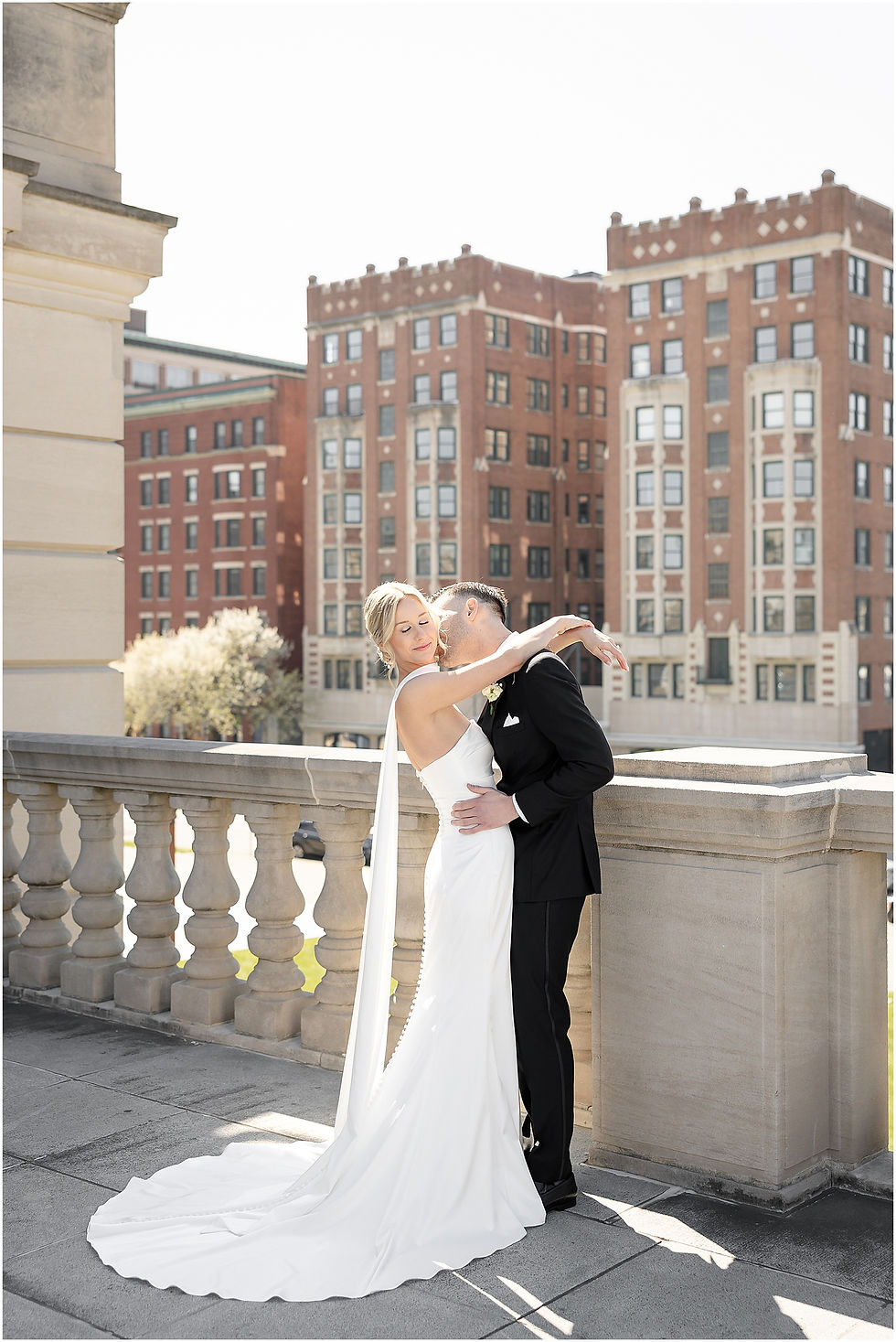 Groom kissing brides neck on spring wedding day in Indianapolis