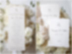 Detail photos of invitation and vow books surrounded by white flowers in Indianapolis